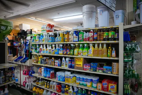 An aisle stocked with household cleaners, detergents and sprays