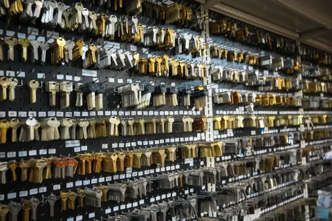 Rows of brass and silver key blanks hanging on a display wall