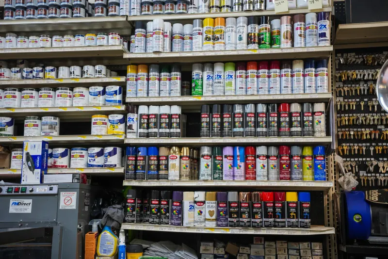 Shelves of spray paint cans in a range of colours