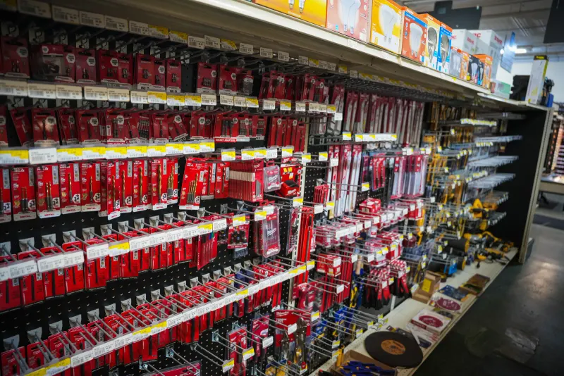 A wall of packaged drill bits, driver bits and saw blades in the tool aisle