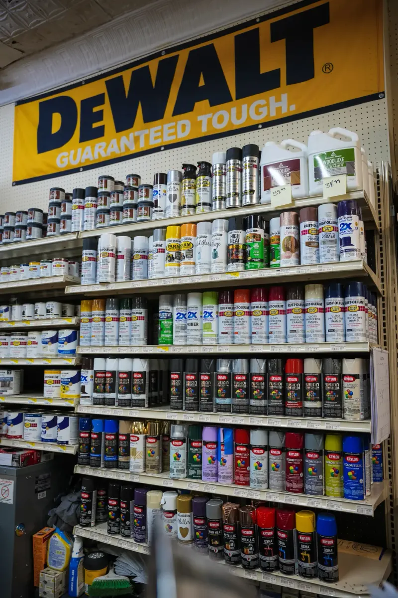 A DeWalt banner above shelves of aerosol sprays and lubricants