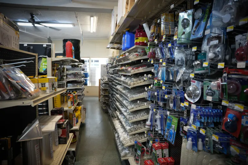 A long aisle of packaged hardware stretching toward the back of the store