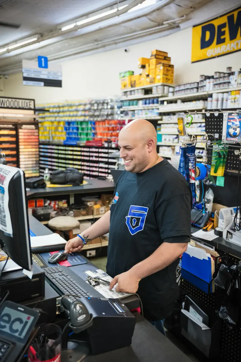 Mike, the owner, working behind the service counter at Yonkers Paint & Hardware